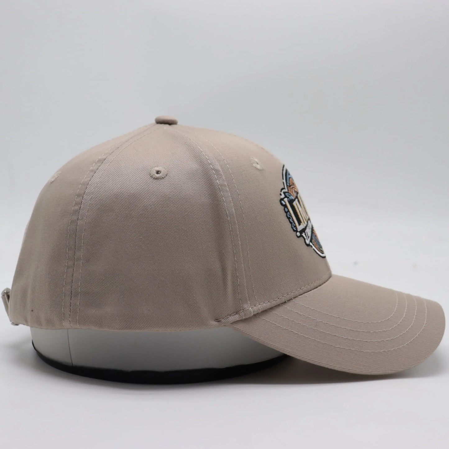 Side view of The TideTurner hat in ivory color highlighting the detailed stitching and durable yet soft texture of its recycled materials.